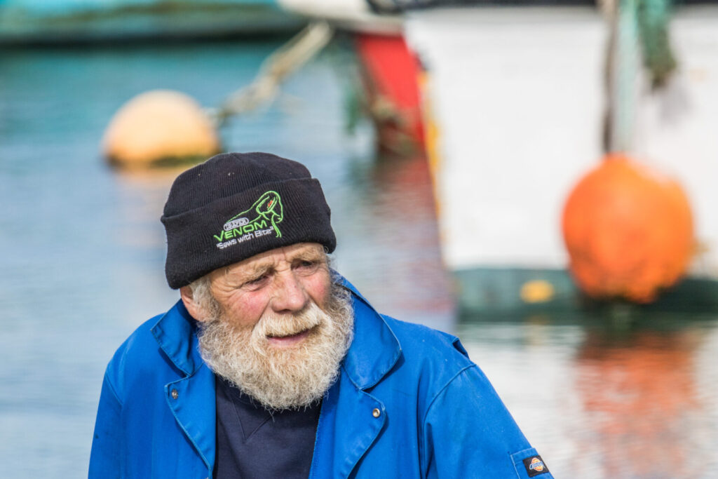 old bearded sailor by a ship